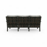 Wicker outdoor sofa with cushions on a white background