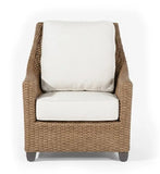 Wicker armchair with white cushions on a white background